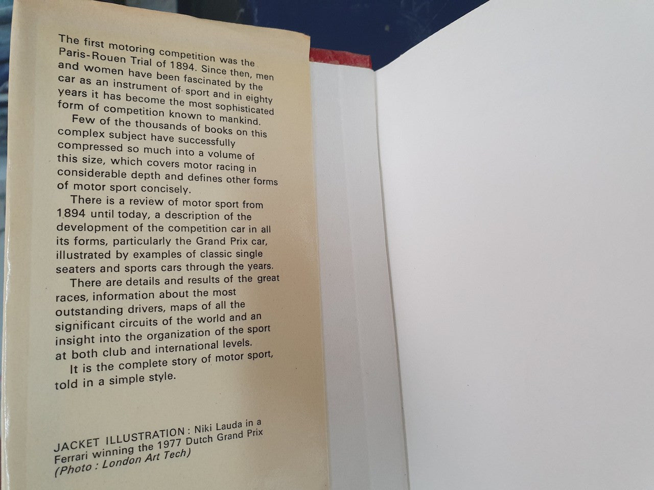 Motor sport book page with paragraphs of text and a jacket illustration caption