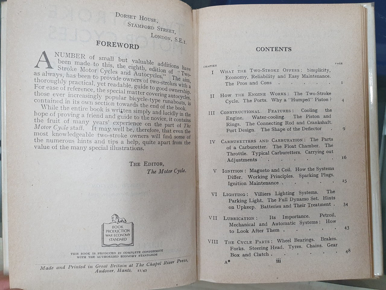 Open hardcover book page with foreword text and contents headings