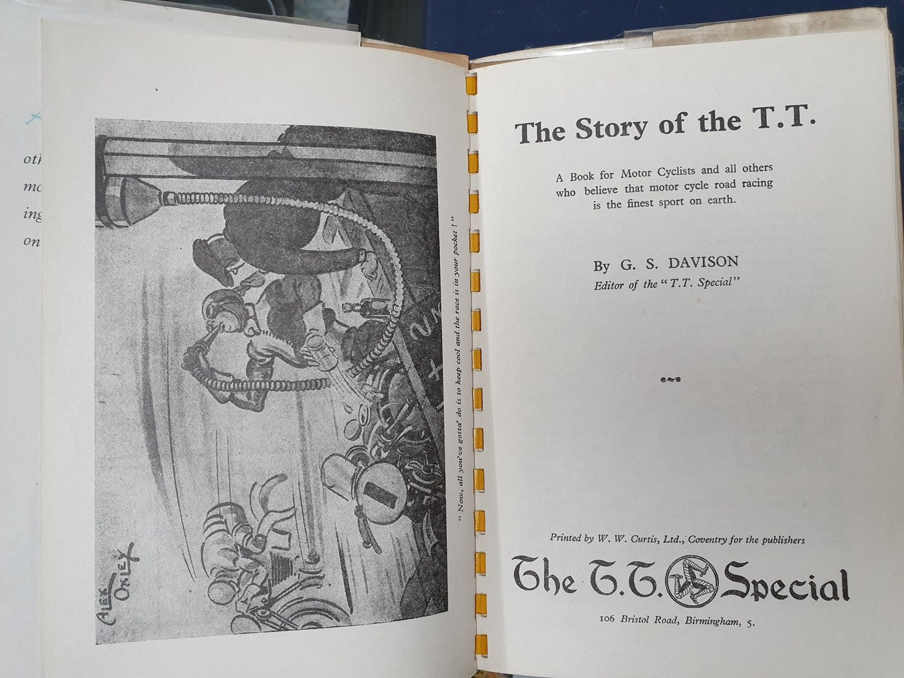 Open hardcover book with title page on right and motor racing illustration on left.