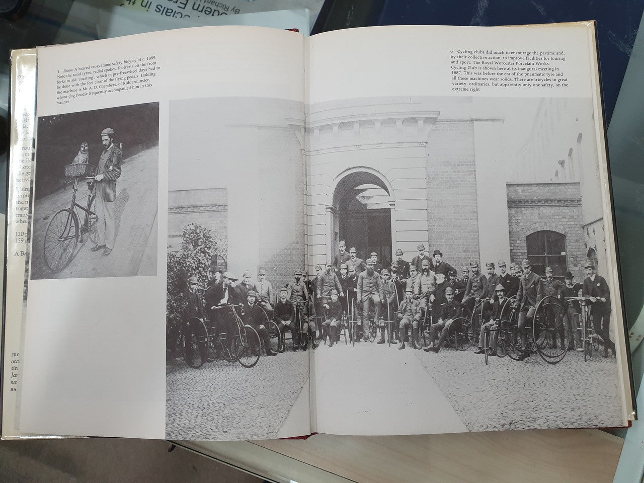 Open book showing black-and-white photos of bicycles and a building