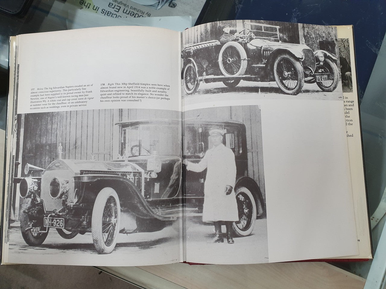 Open book page with black-and-white vintage car photographs