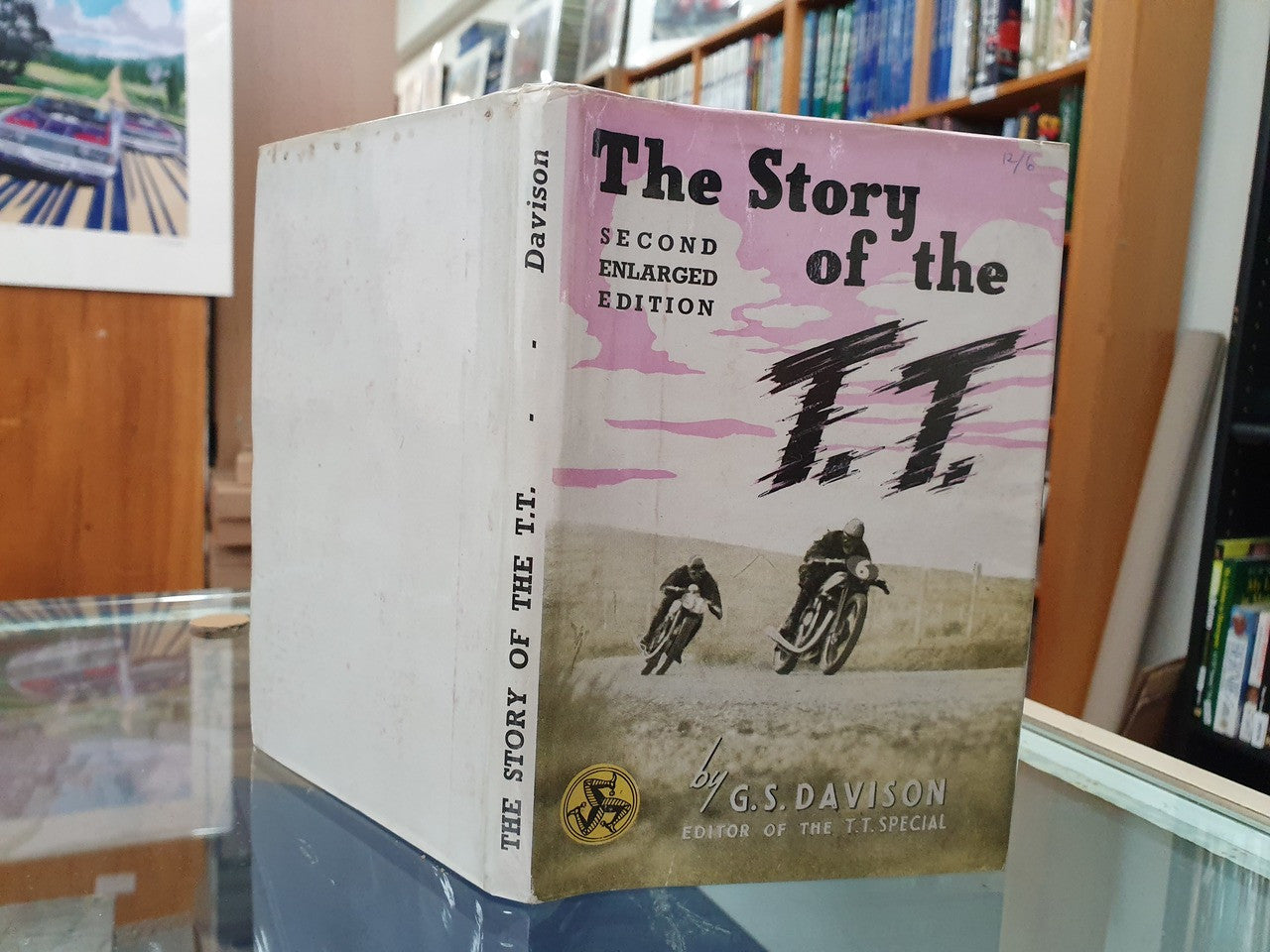 Hardcover book standing with purple cover showing 'The Story of the T.T.'