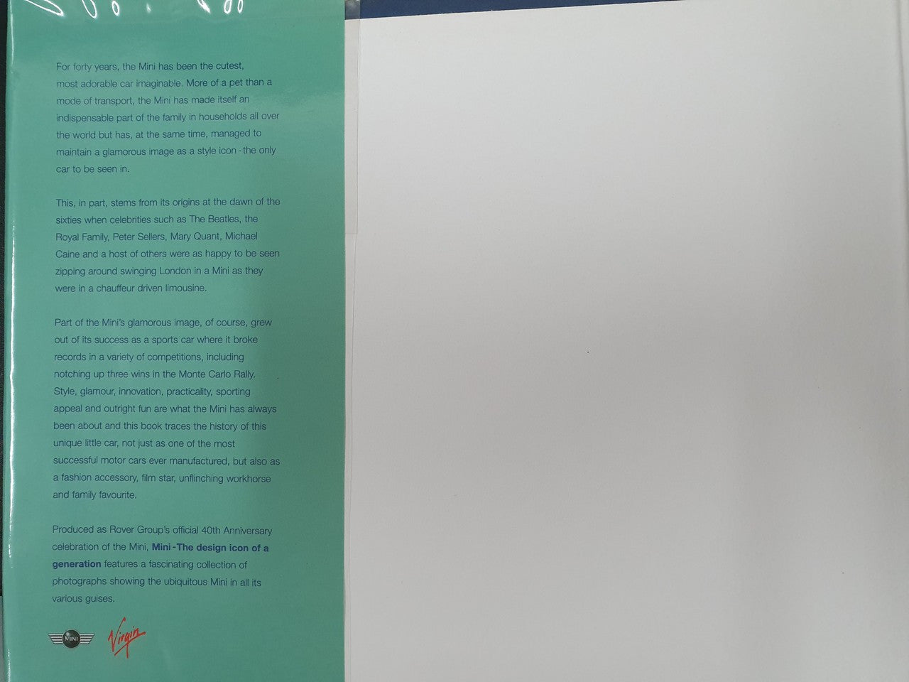 Hardcover book page with teal text column and small emblem near bottom