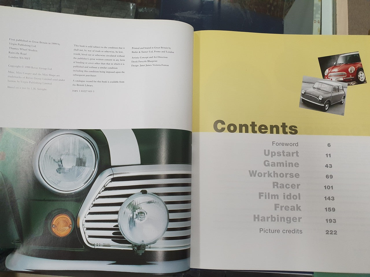 Open hardcover book showing car headlight close-up and Contents page