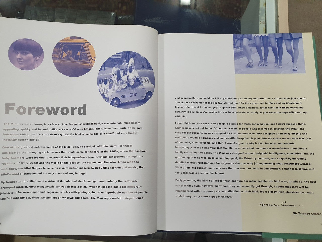 Open hardcover book with Foreword page and blue circular photo graphics