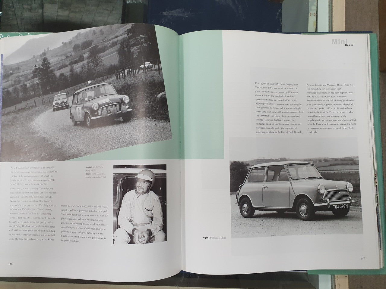 Open hardcover book spread with black-and-white Mini car photos and portrait