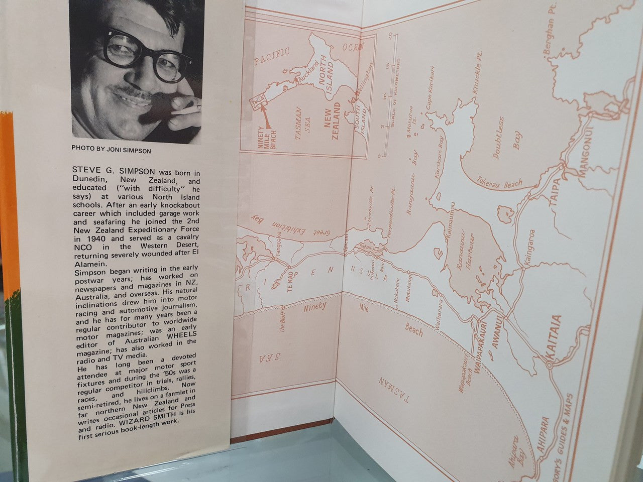 Hardcover book open to photo caption and map spread with country outlines