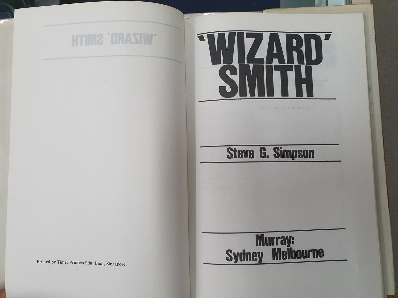 Hardcover book open to title page with "WIZARD" and "SMITH" headings