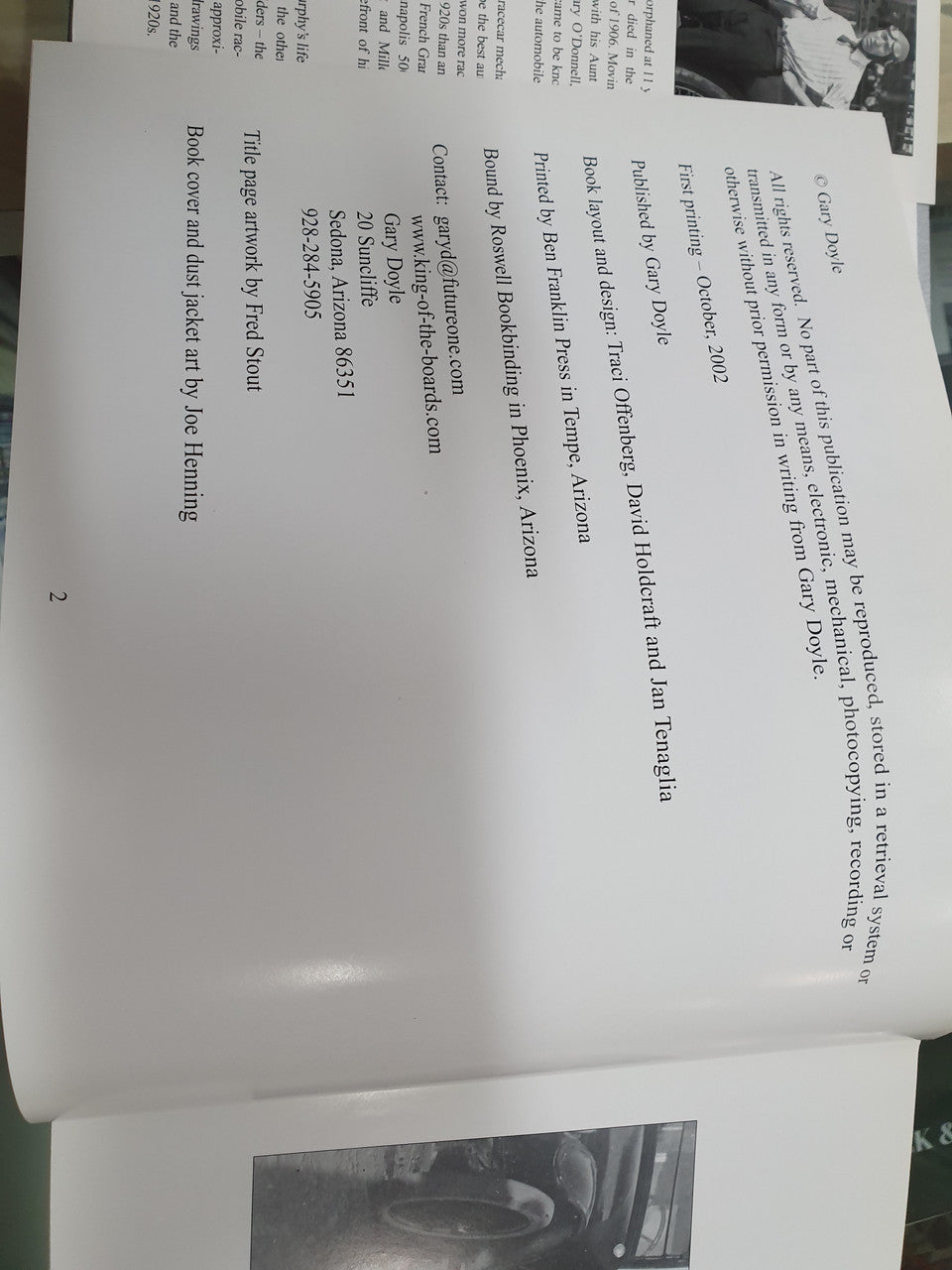 Signed history book open pages with printed text and small photo inserts