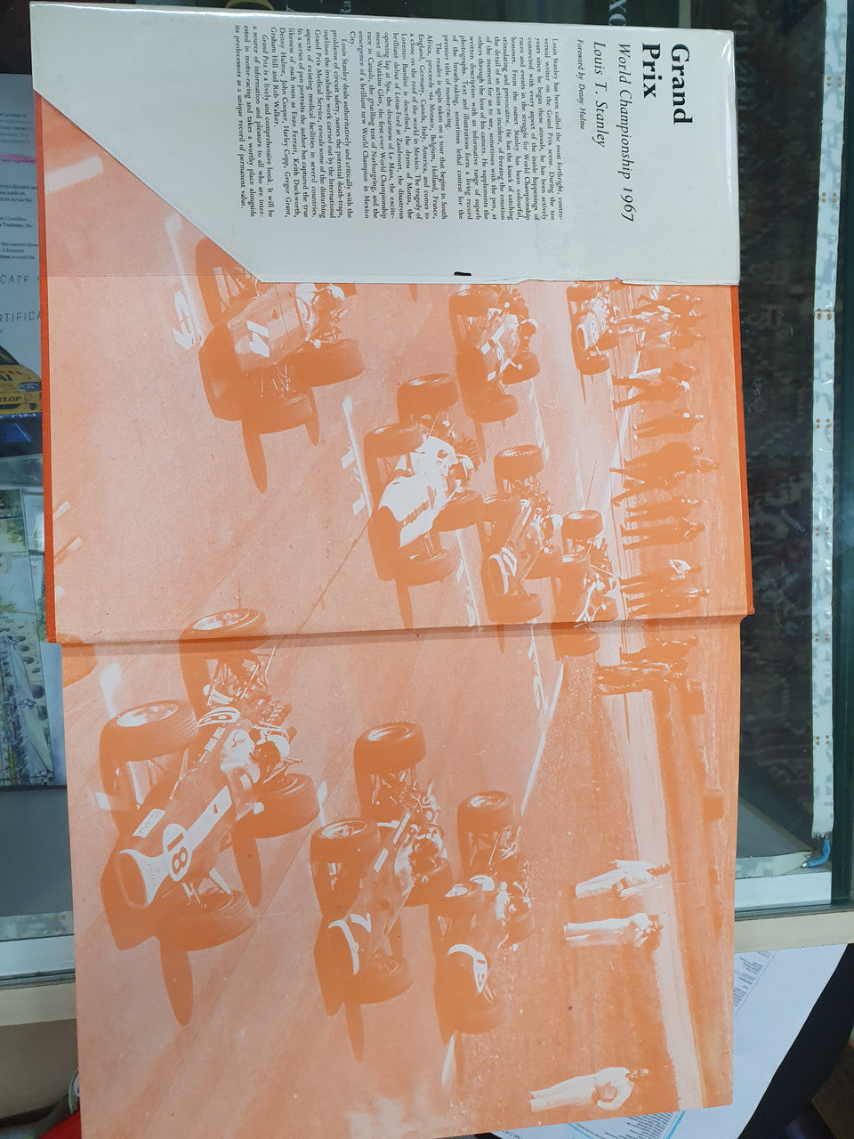 Grand Prix World Championship book back cover with orange illustration and white text panel