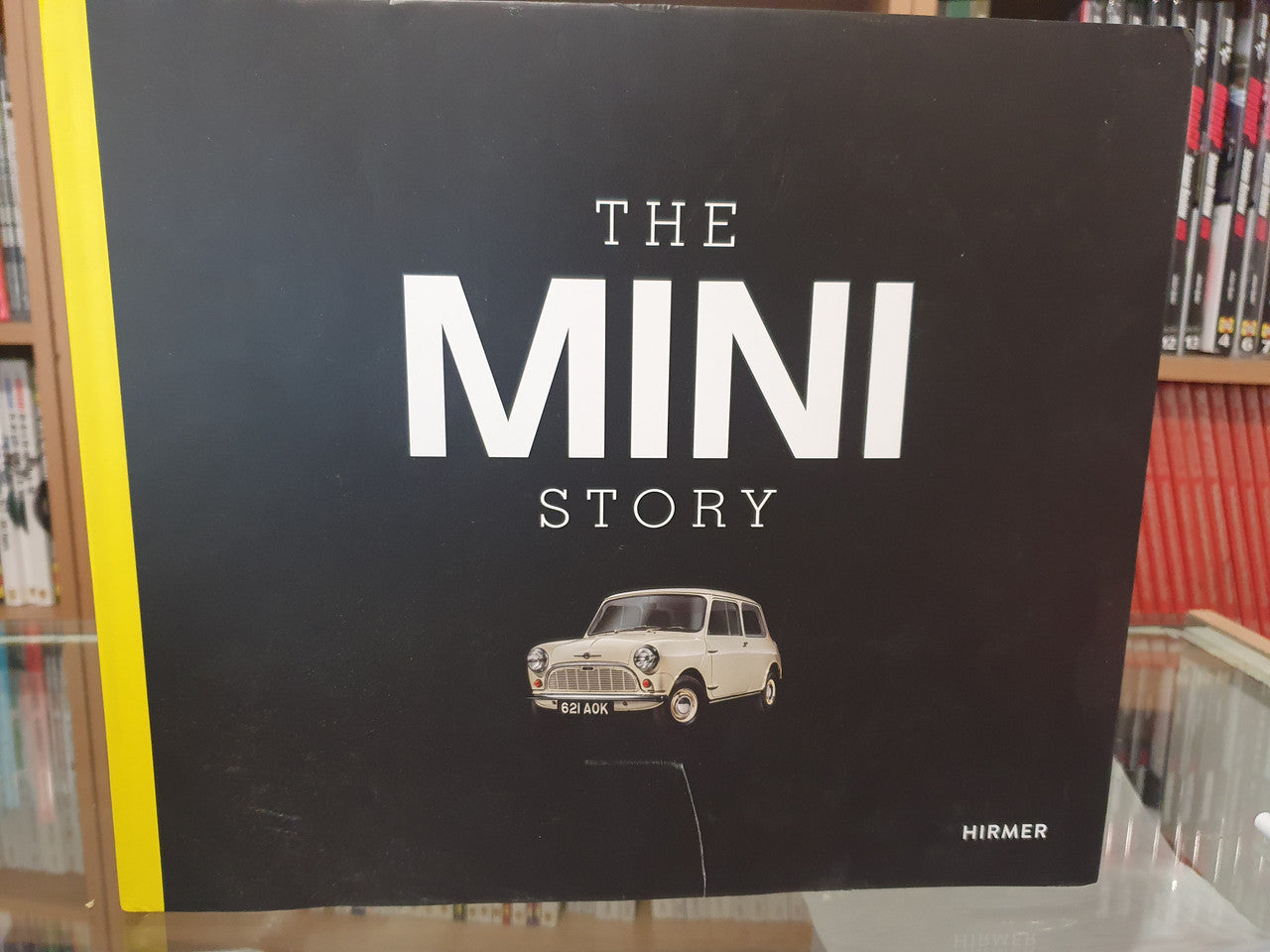 Classic car book cover with THE MINI STORY title and small cream Mini