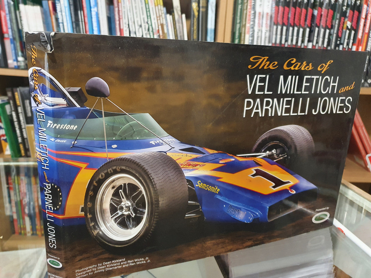 Race car book cover showing blue/yellow formula car illustration and author names