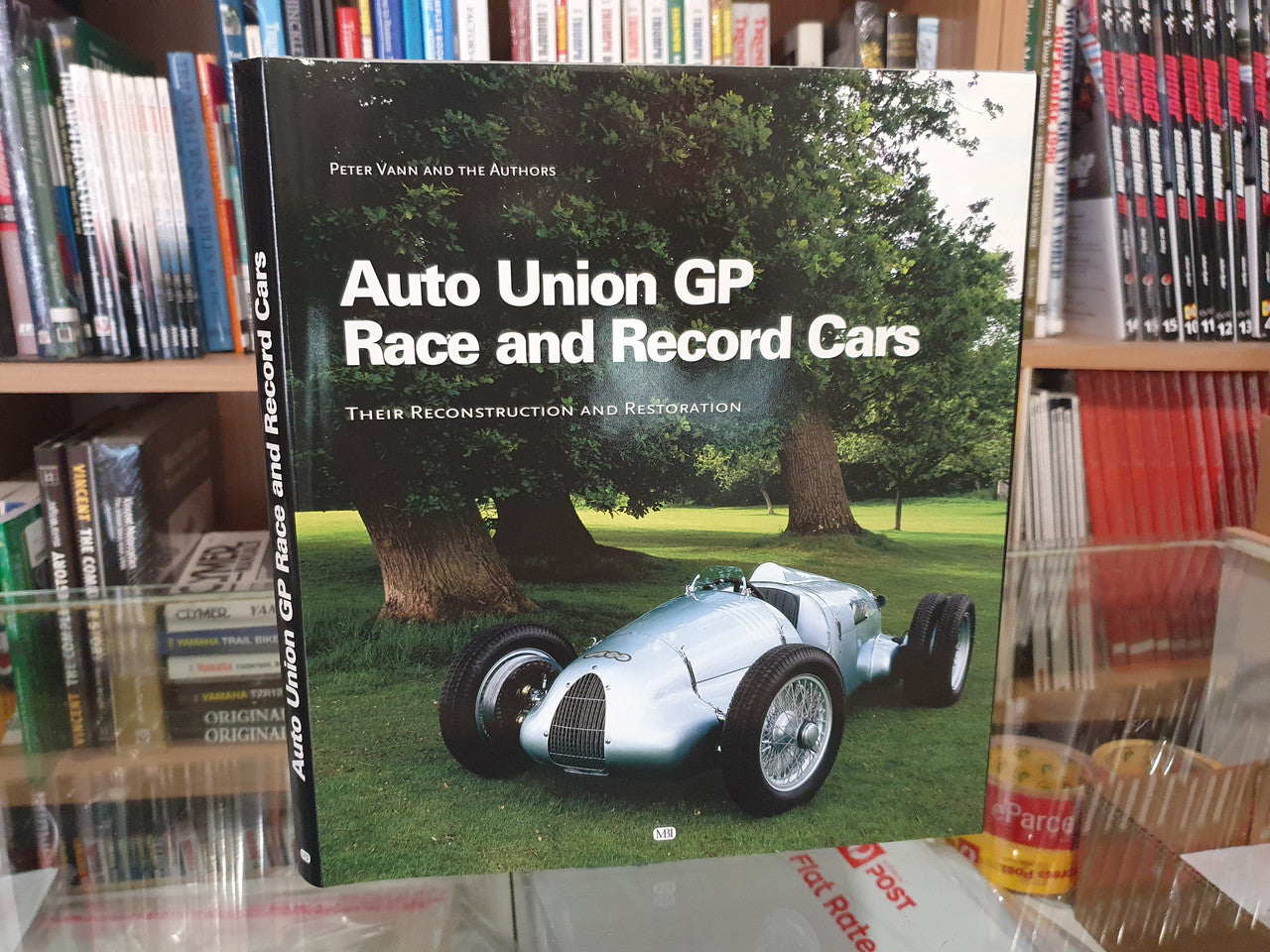Auto Union GP race car book on shelf, cover shows title and silver vintage car