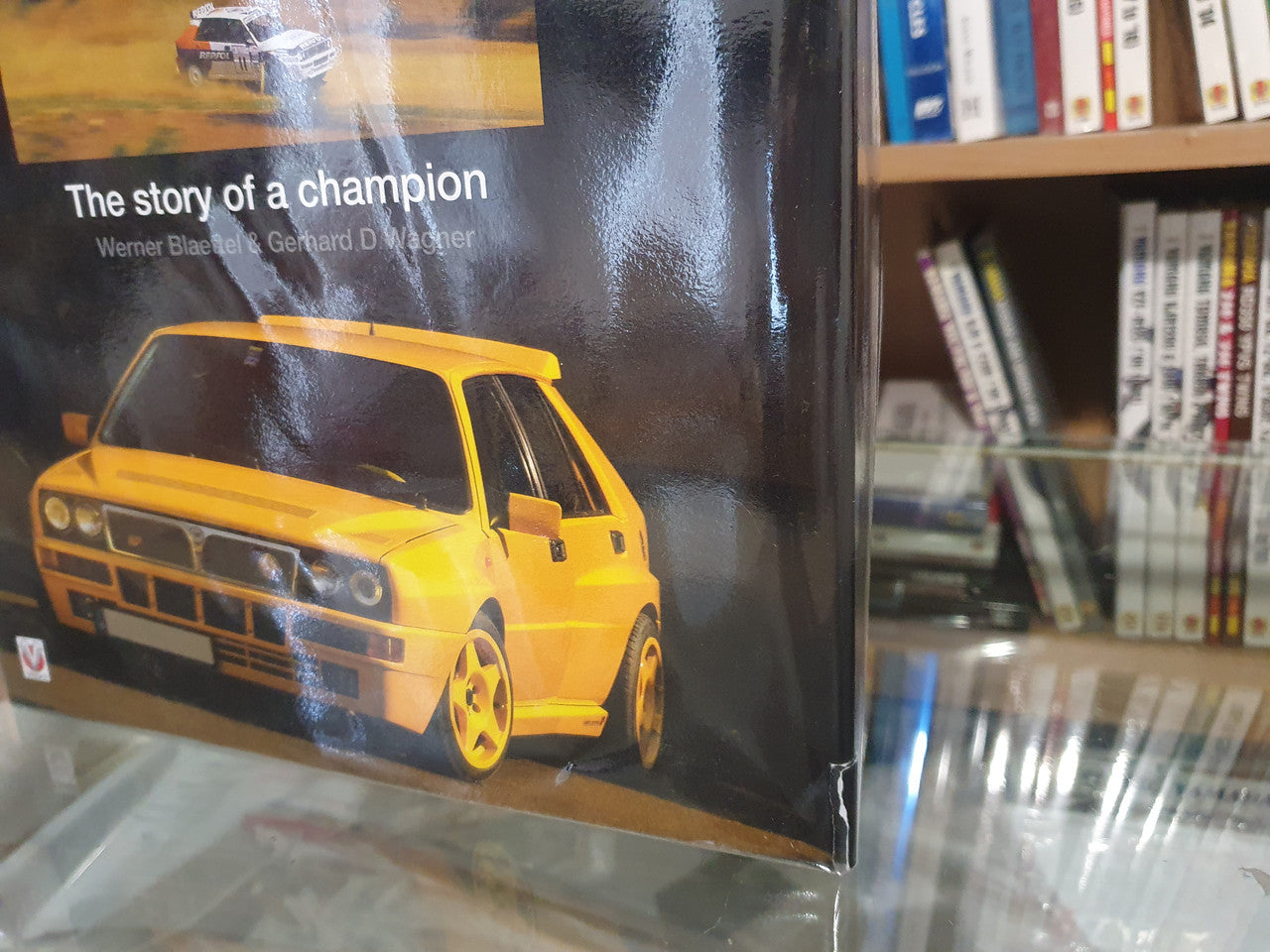 Racing book cover close-up with yellow car and front title text