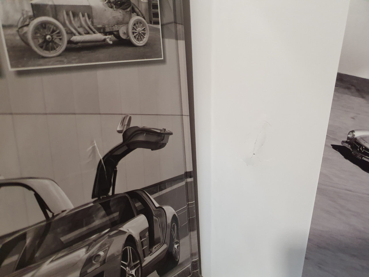 Open book spread with dark and white Mercedes-Benz supercar photos on display