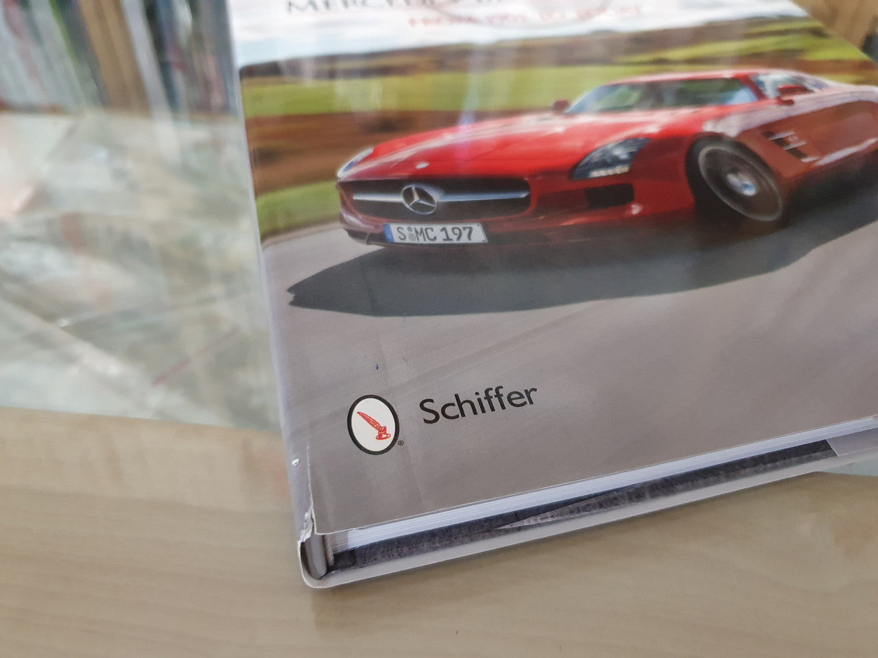 Book corner with red Mercedes-Benz supercar photo and Schiffer logo