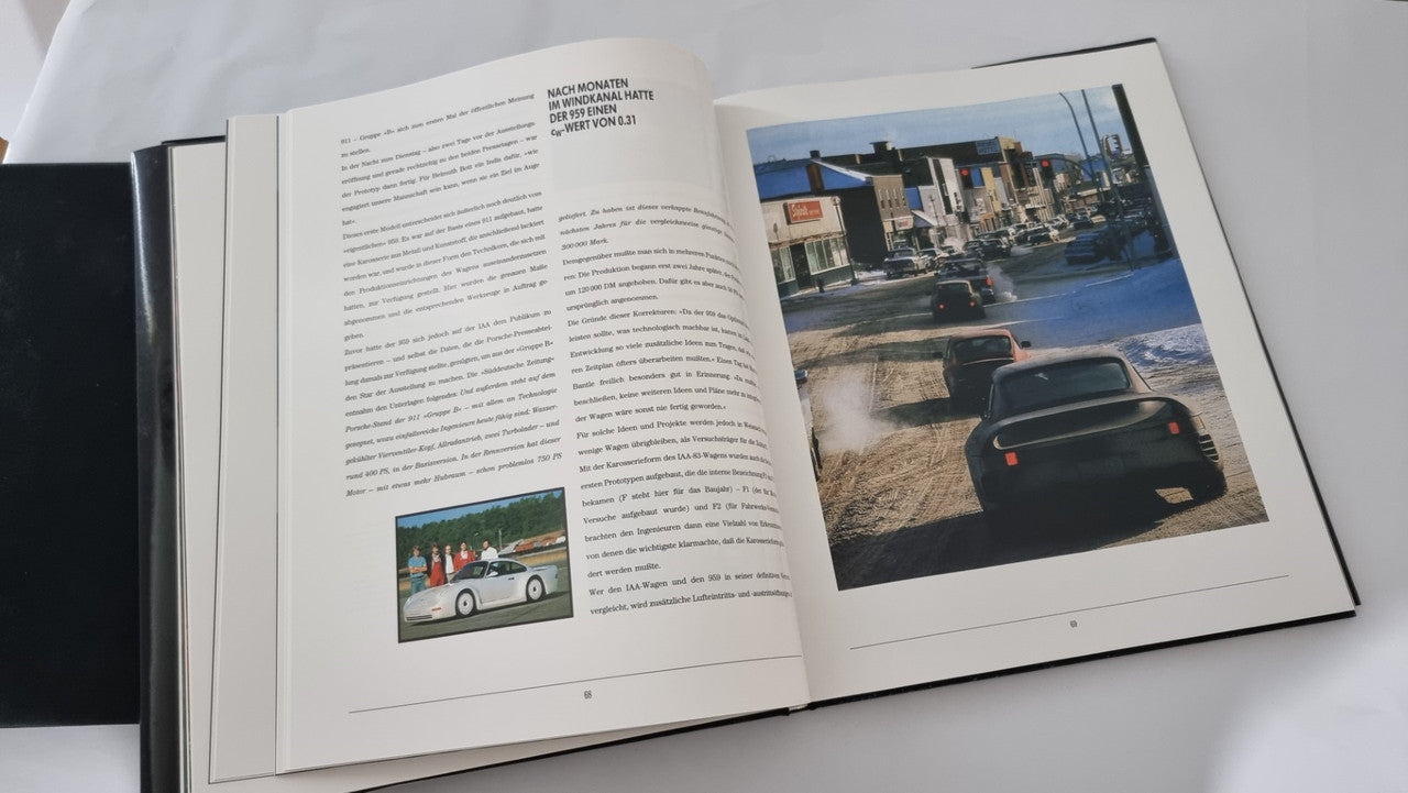 Open art book with text pages and color photo of a car on track