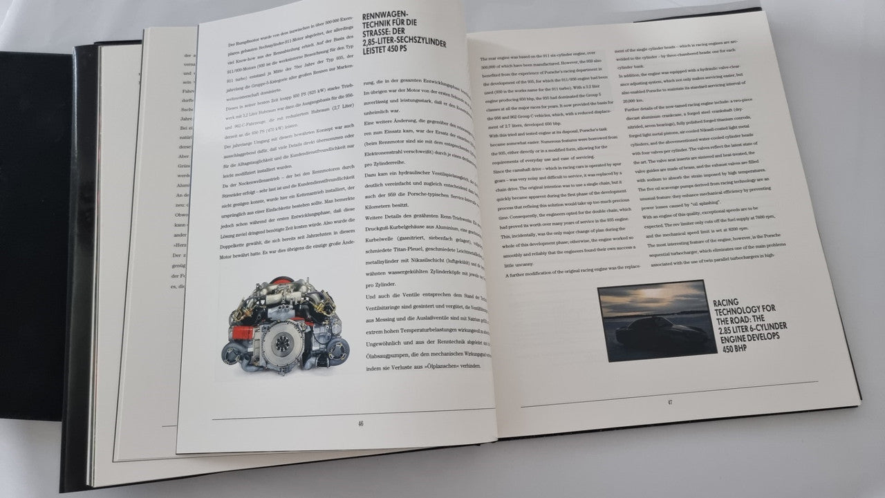 Open art book with dense text pages and small engine photograph