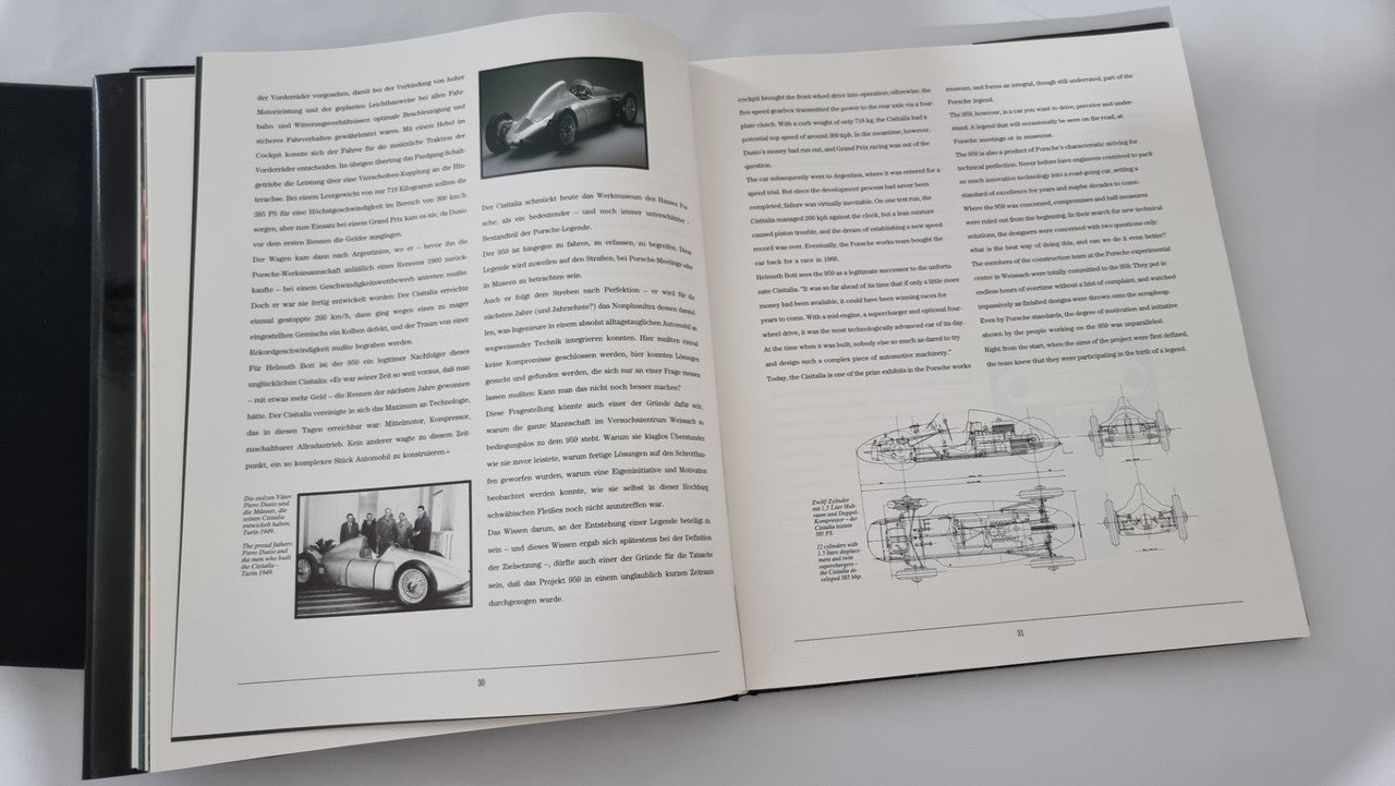Open art book with technical text, small car photo, and diagram sketches