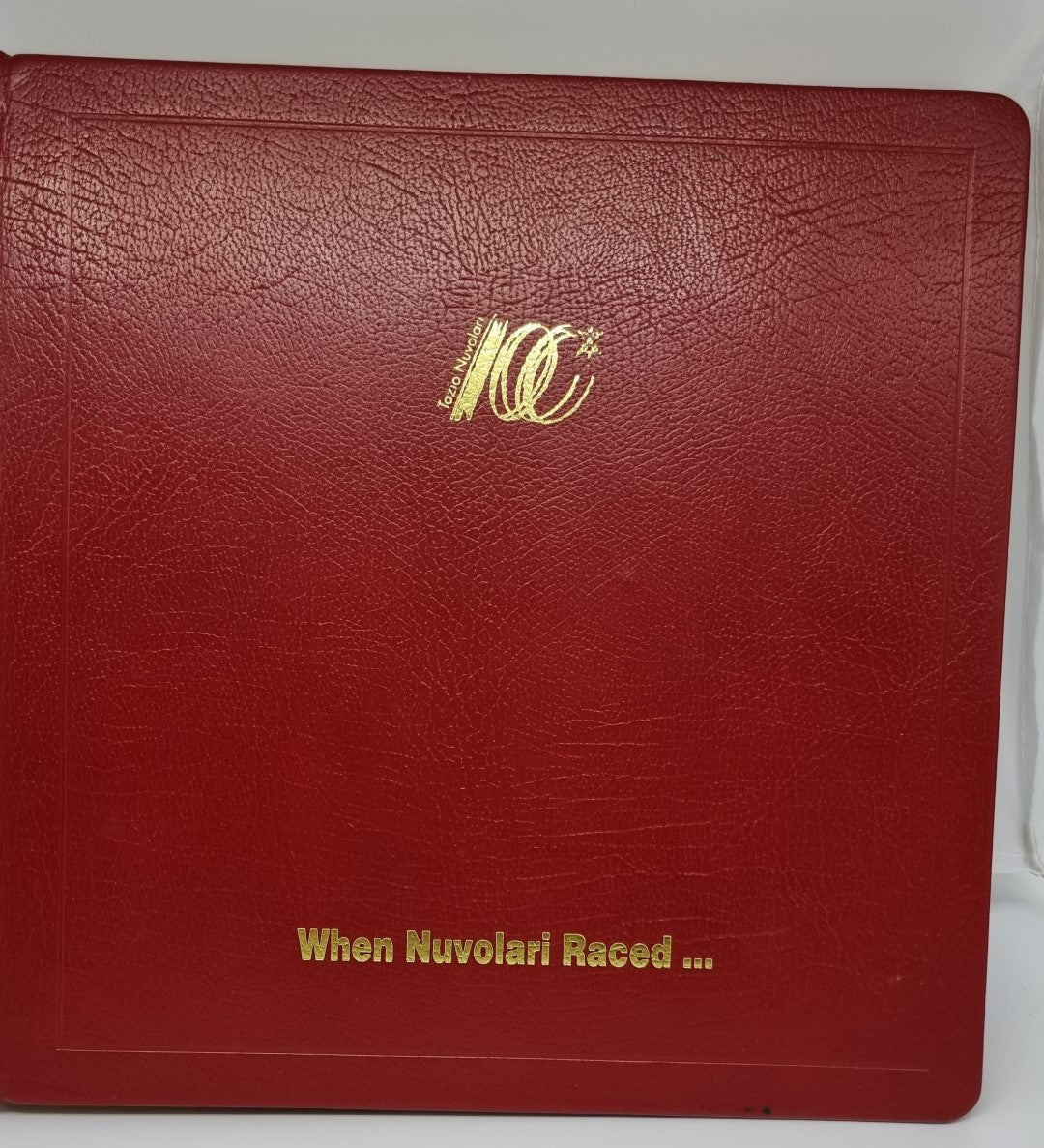 Maroon leather-bound book with gold NV emblem and title on cover