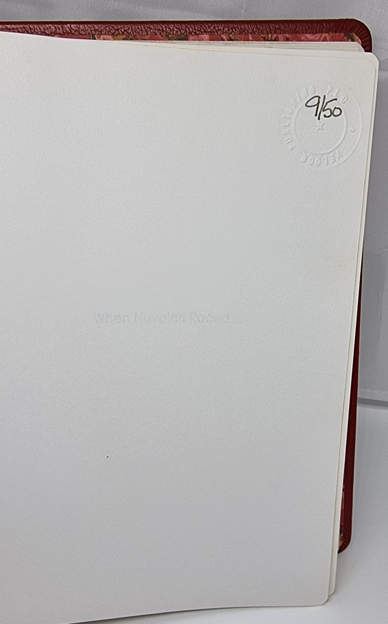 Maroon leather-bound book cover with white page edges