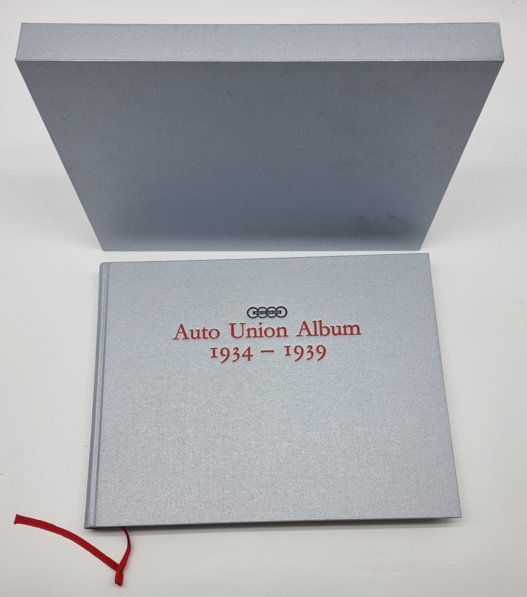 Grey slipcase with red title text and Auto Union rings logo on front cover