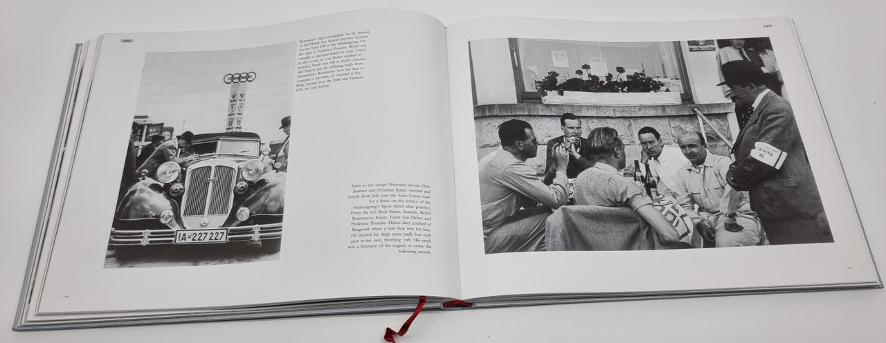 Open hardcover photo album with black-and-white racing car images across two pages