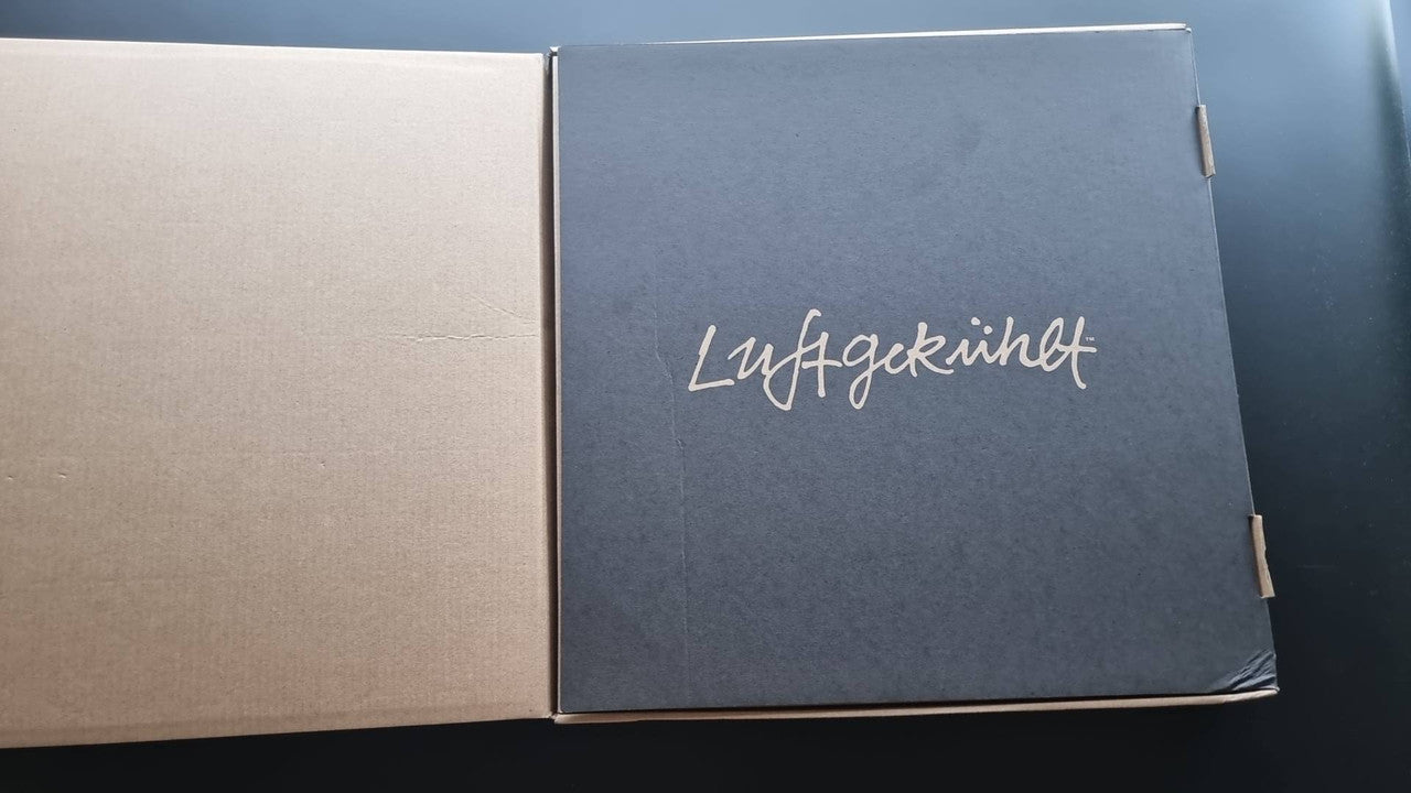 Blue Luftgekuhlt booklet cover with cursive logo on open folder