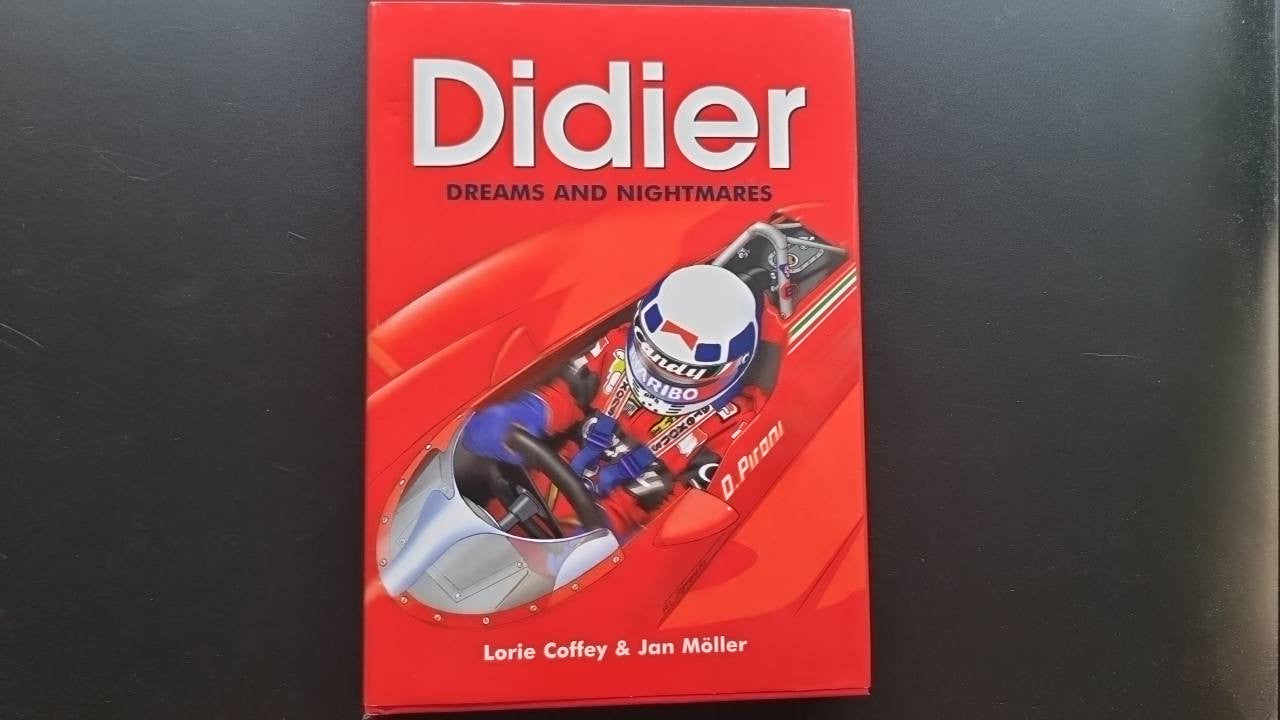 Red hardcover book cover with title text and racing car illustration
