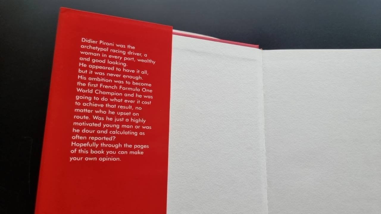 Red dedication or foreword page with paragraph text beside a white page