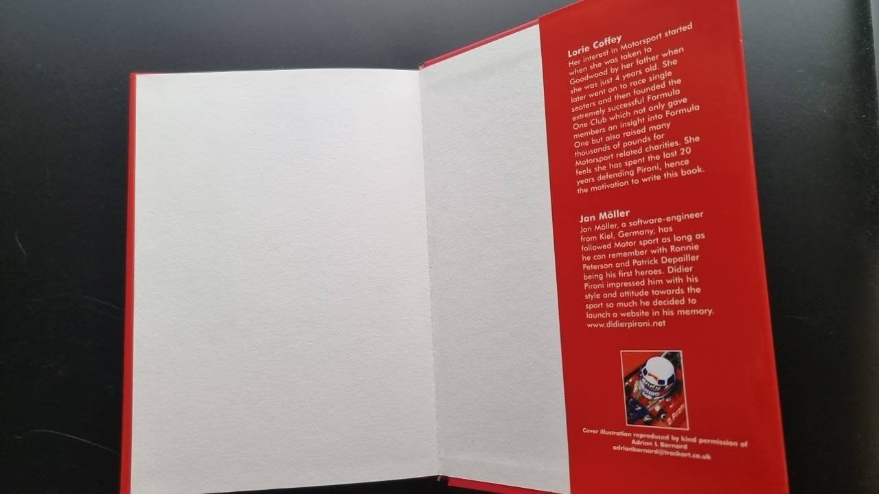 Opened book with blank left page and a right page featuring red paragraph text.