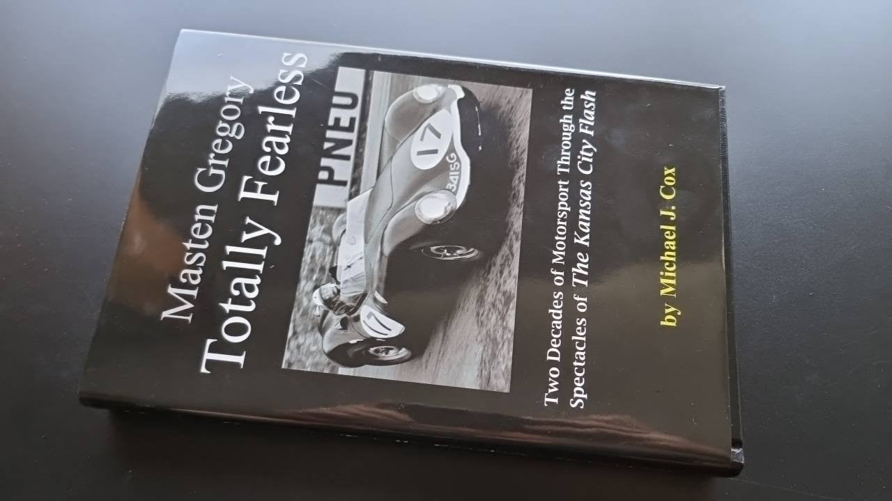 Paperback book cover with racing car photo and title text on cover and spine