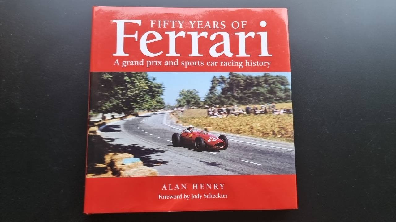 Ferrari Fifty Years book cover with red title and sports car on a road