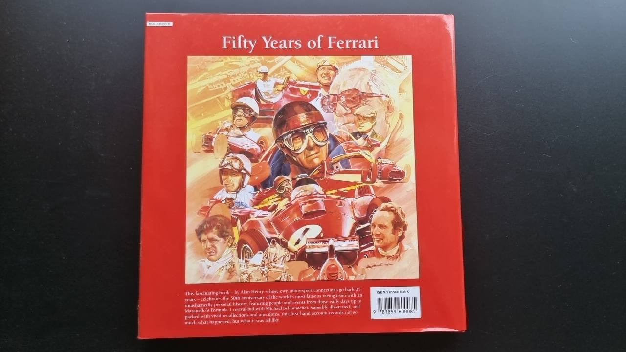 Ferrari racing history book with red cover and illustrated drivers on the front.