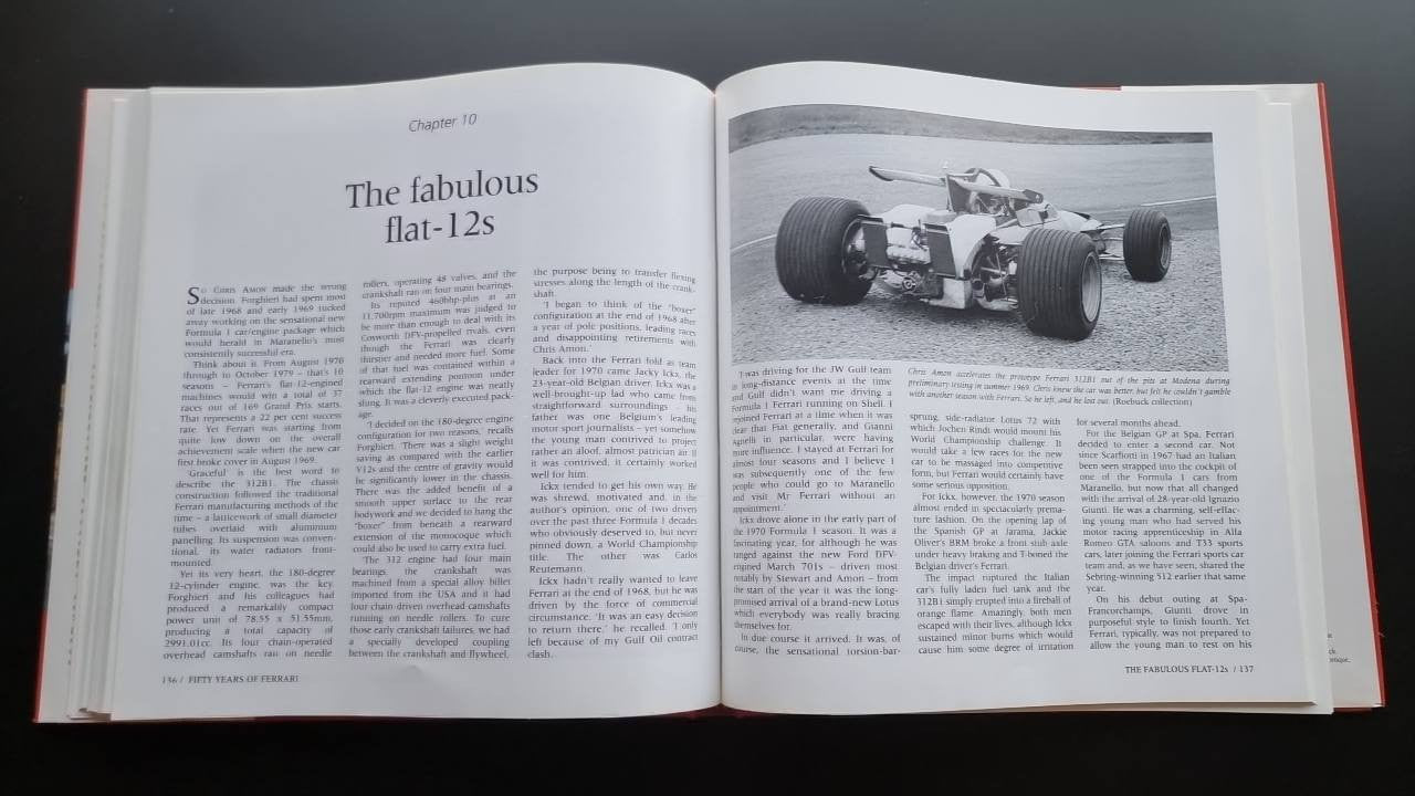 Ferrari racing history book open to text with black-and-white race car photo
