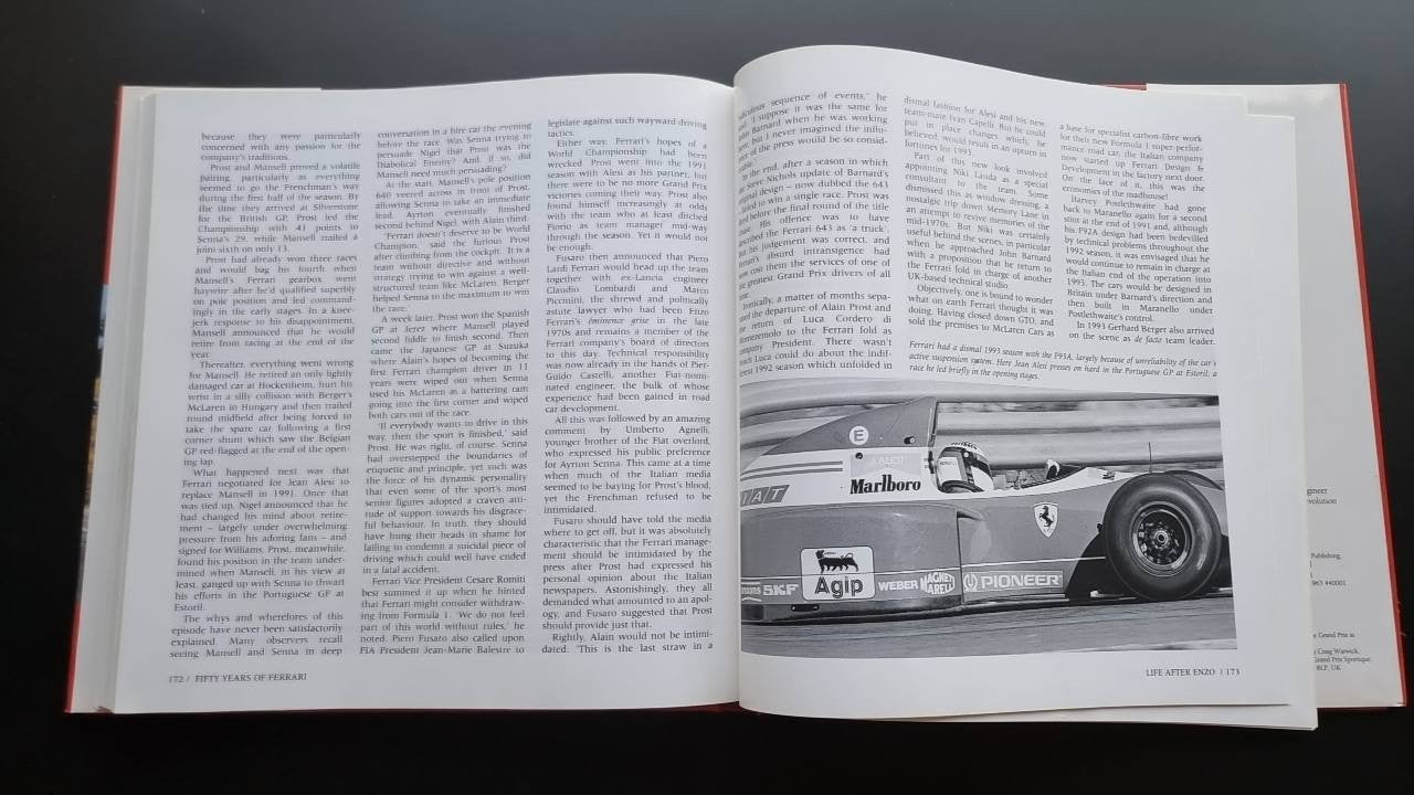 Ferrari racing history book open pages with race car photo strip and text