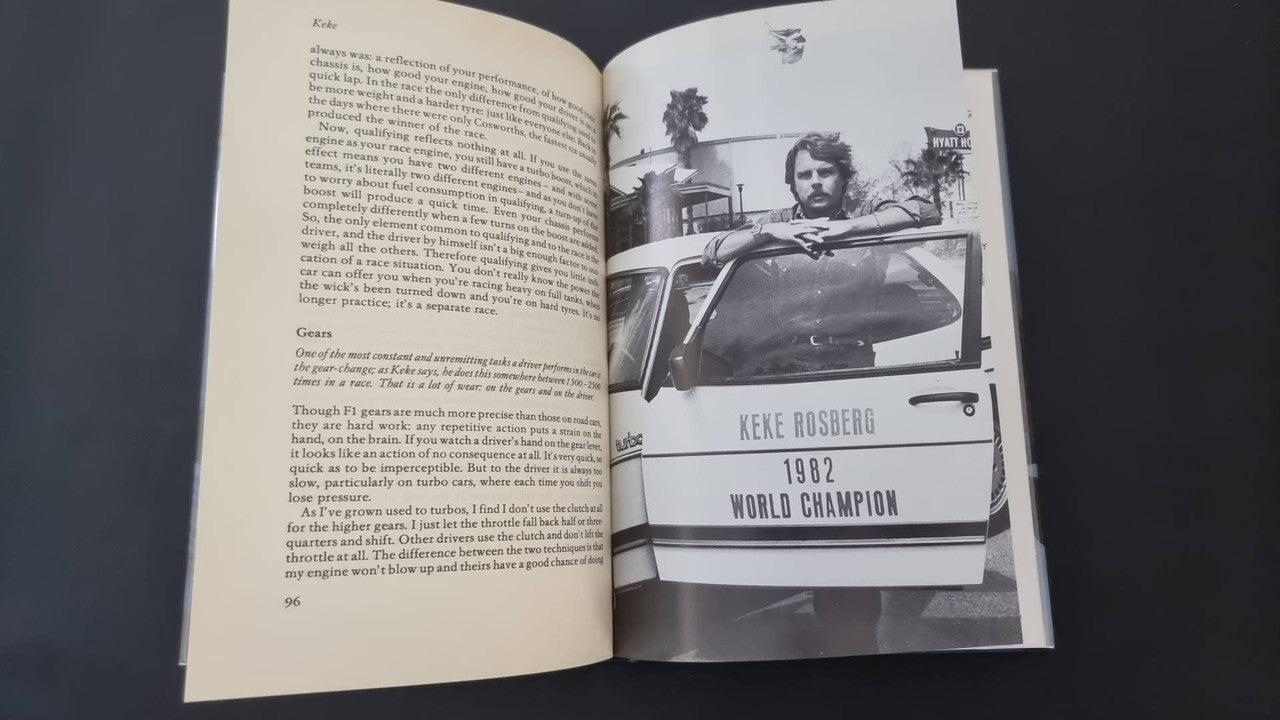 Open book showing a driver portrait and a race car photo with label