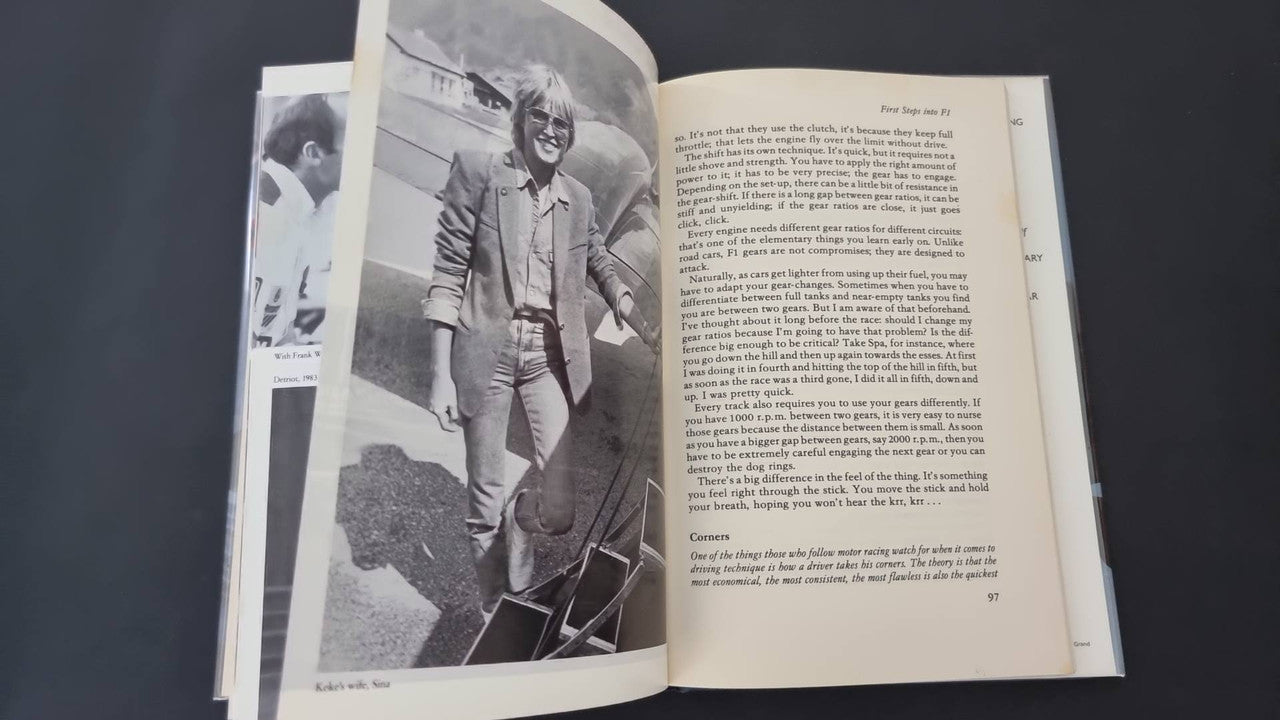 Open book with a standing driver photo and a text page