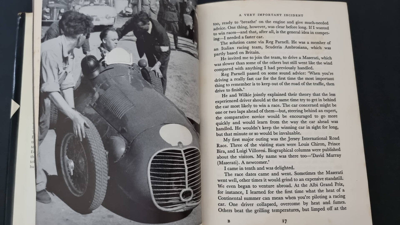 Open book page with black-and-white photo of race car front and people