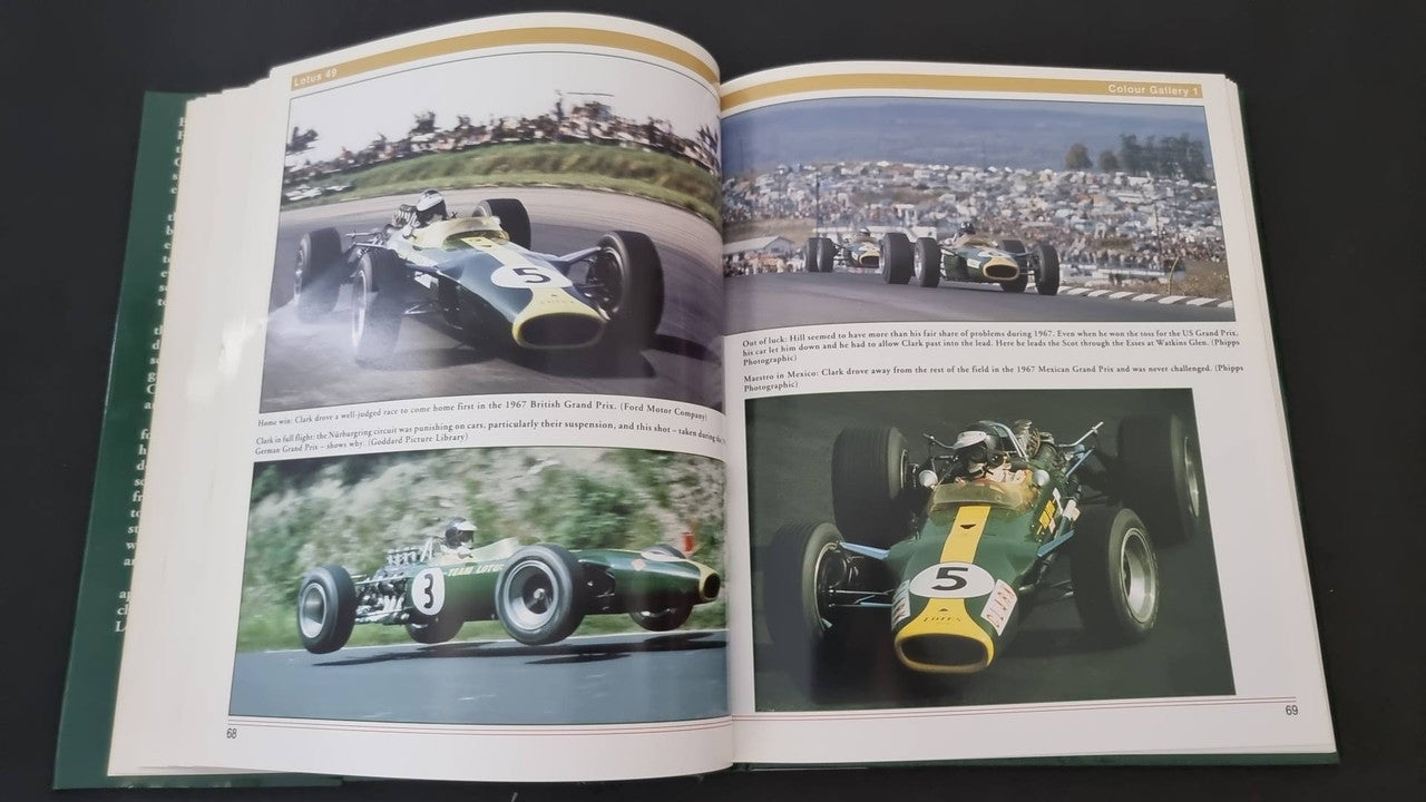 Opened Lotus 49 book showing four photos of race cars on a two-page spread