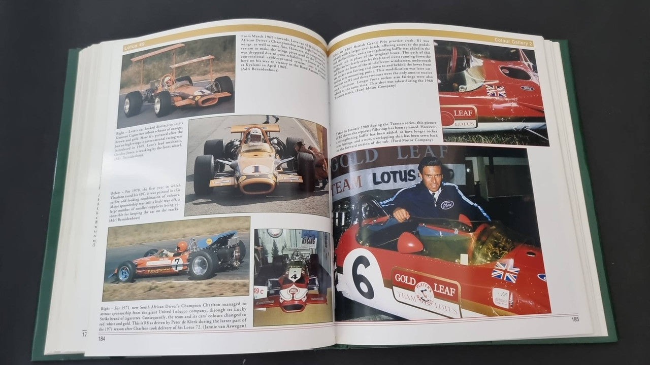 Open motorsport history book with color race photos and printed text pages