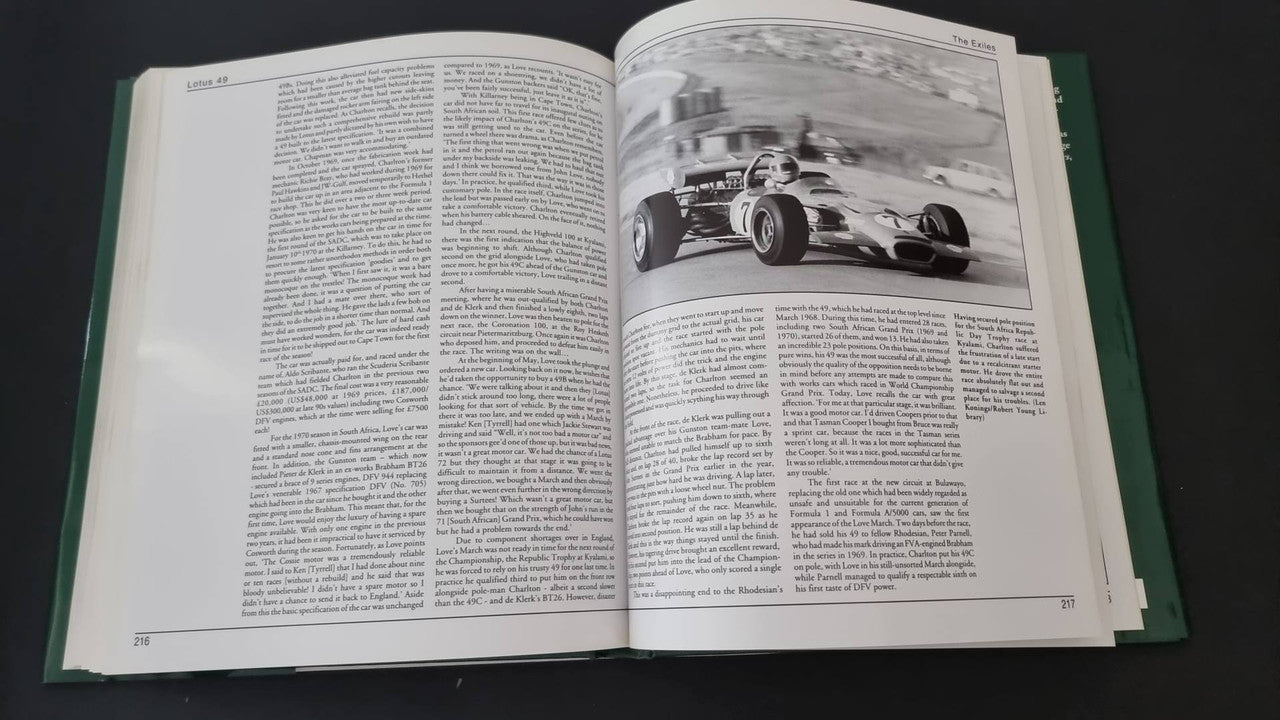 Open motorsport history book with black-and-white race car photo and text columns