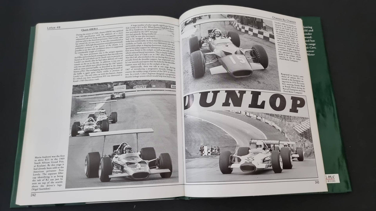 Open motorsport history book showing "DUNLOP" photo and race car images