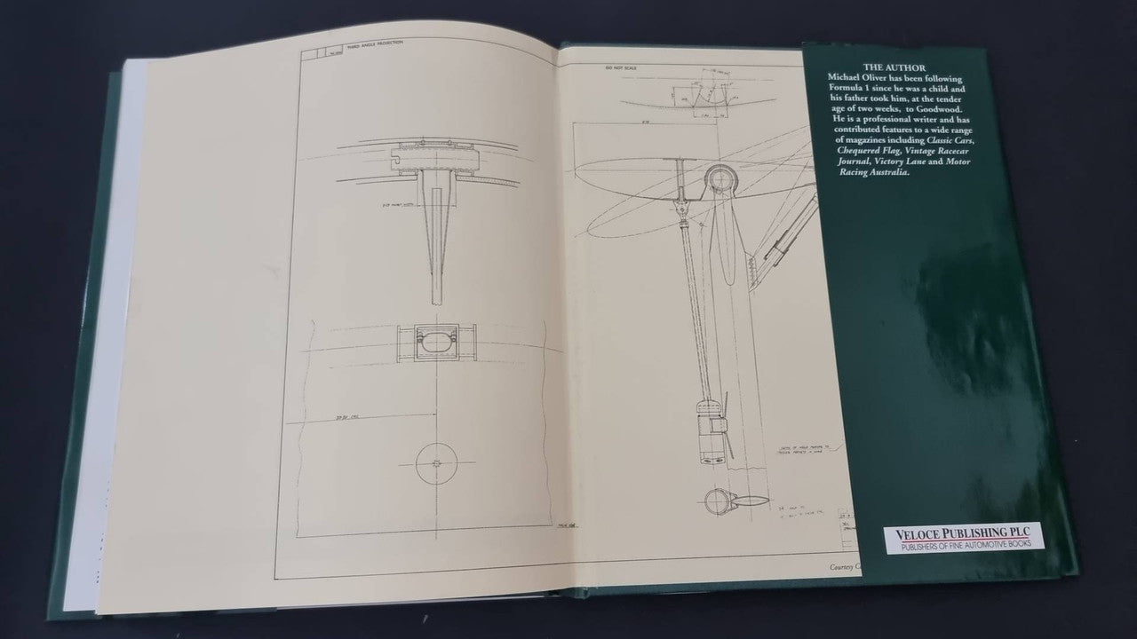 Opened Lotus 49 book showing technical blueprint pages and diagrams
