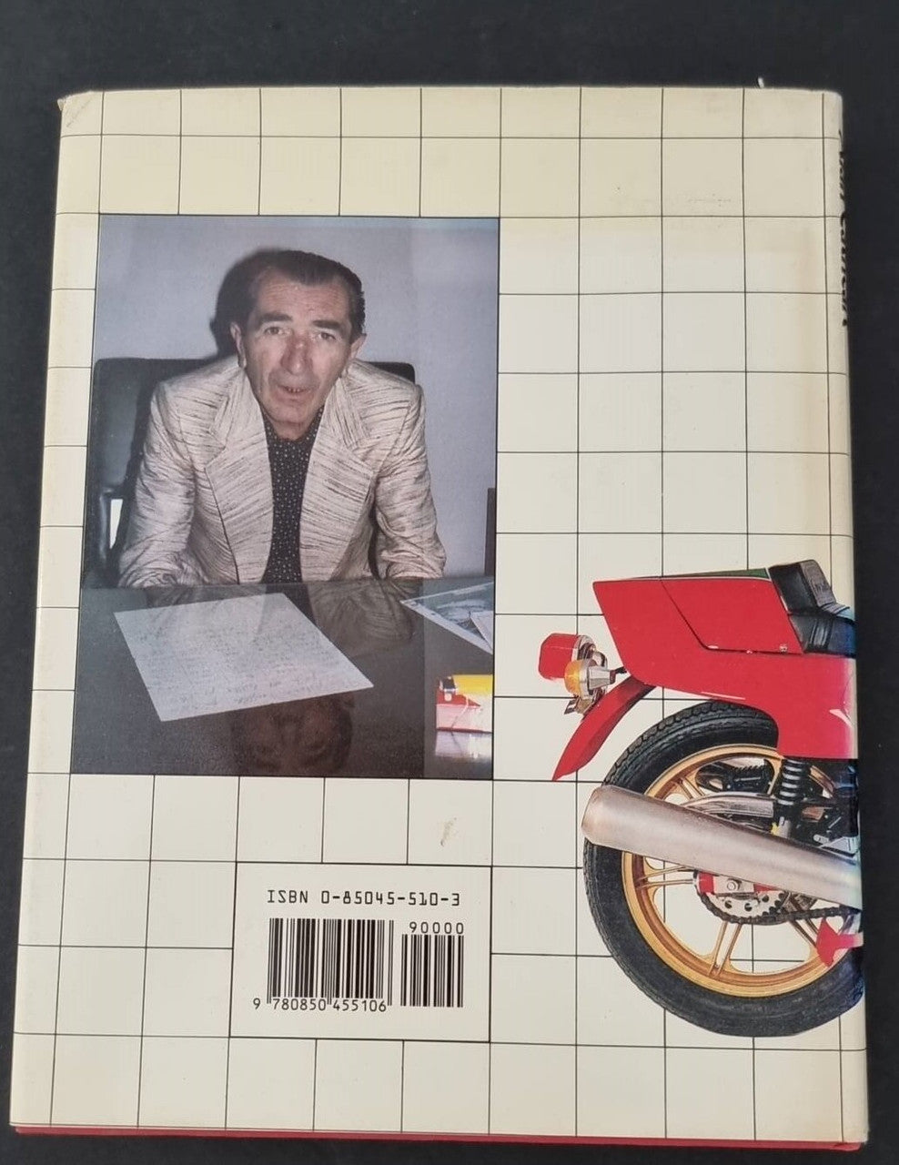 Motorcycle book back cover with portrait, red motorcycle graphic, and ISBN label