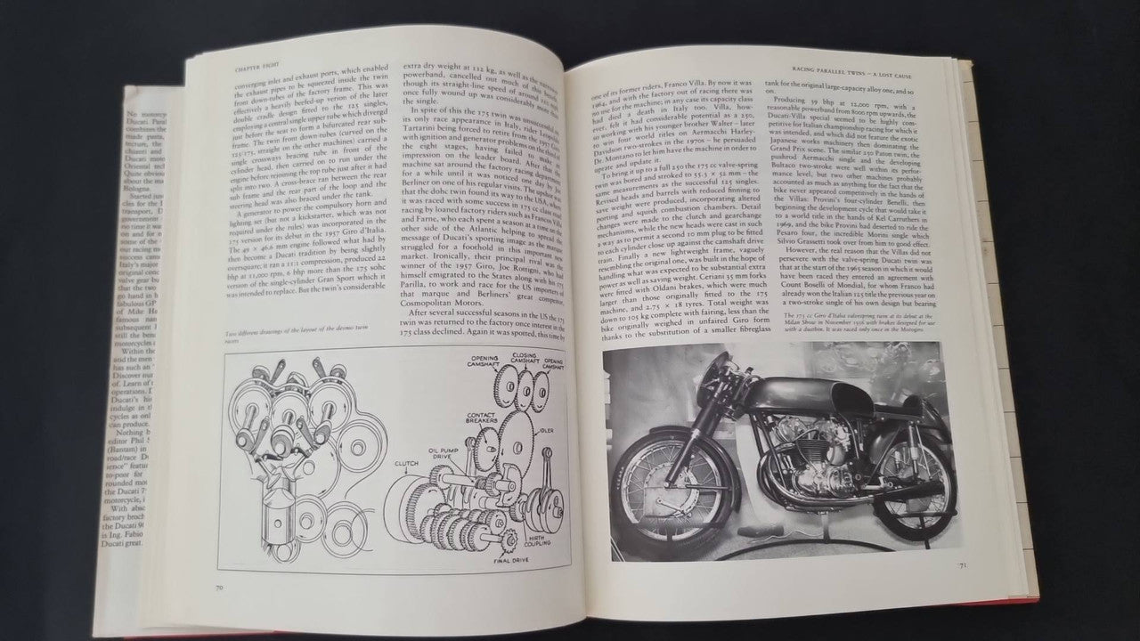 Open motorcycle book pages with diagram illustrations and motorcycle photo