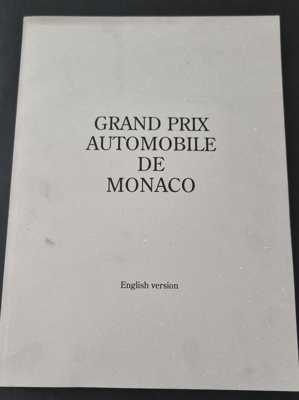 Book front cover with “GRAND PRIX AUTOMOBILE DE MONACO” and “English version”