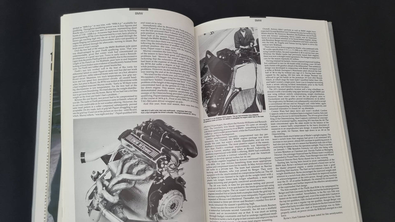 Opened motorsport book with large engine photo and text paragraphs on both pages