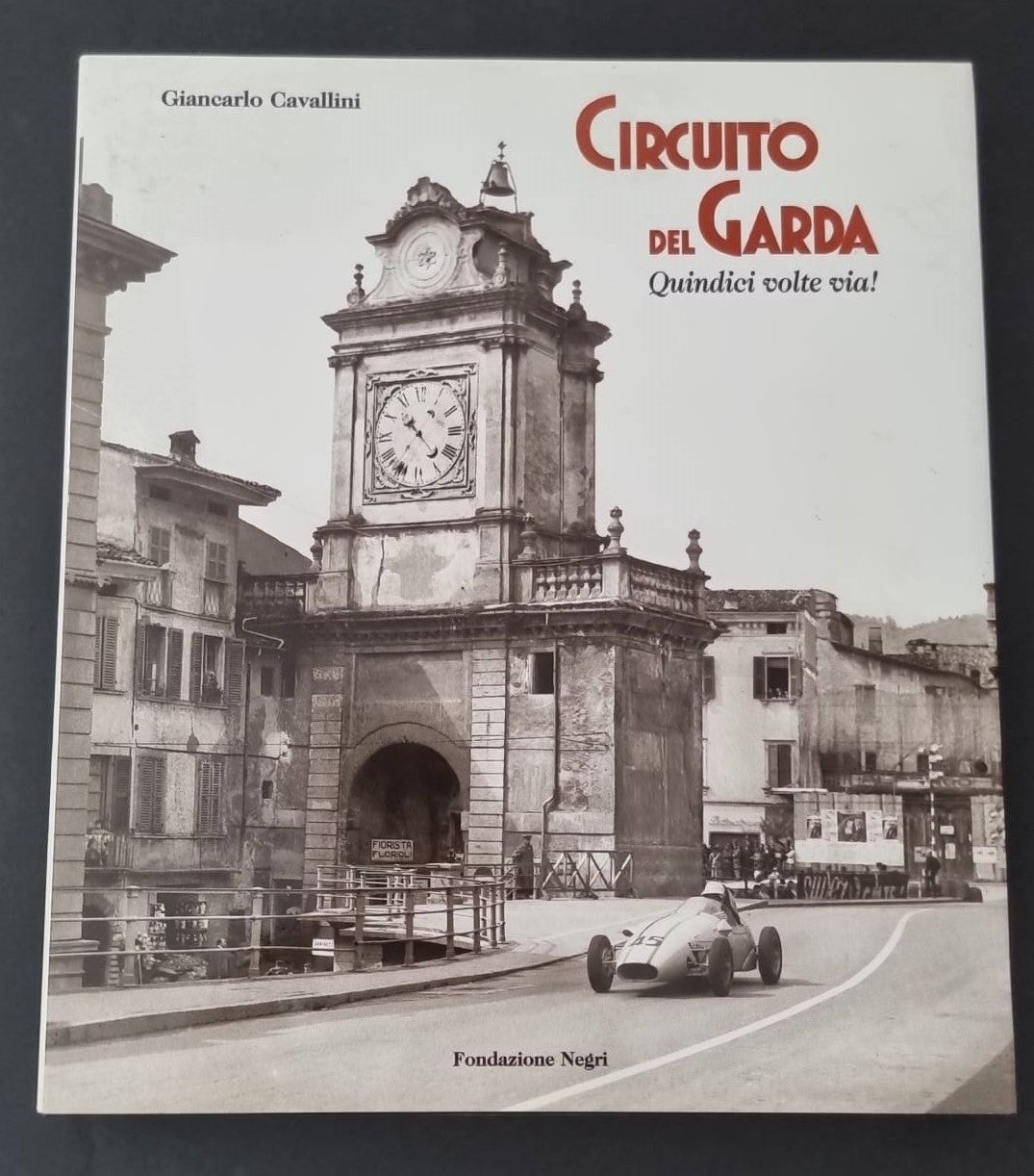 Circuit of Lake Garda book cover with clock tower, road and racing car illustration
