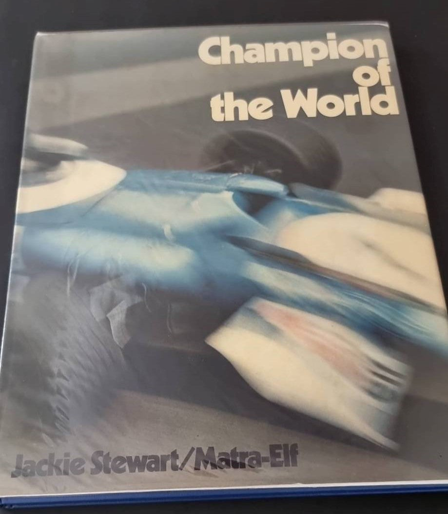 Champion of the World book cover, blue racing car photo with title text at top